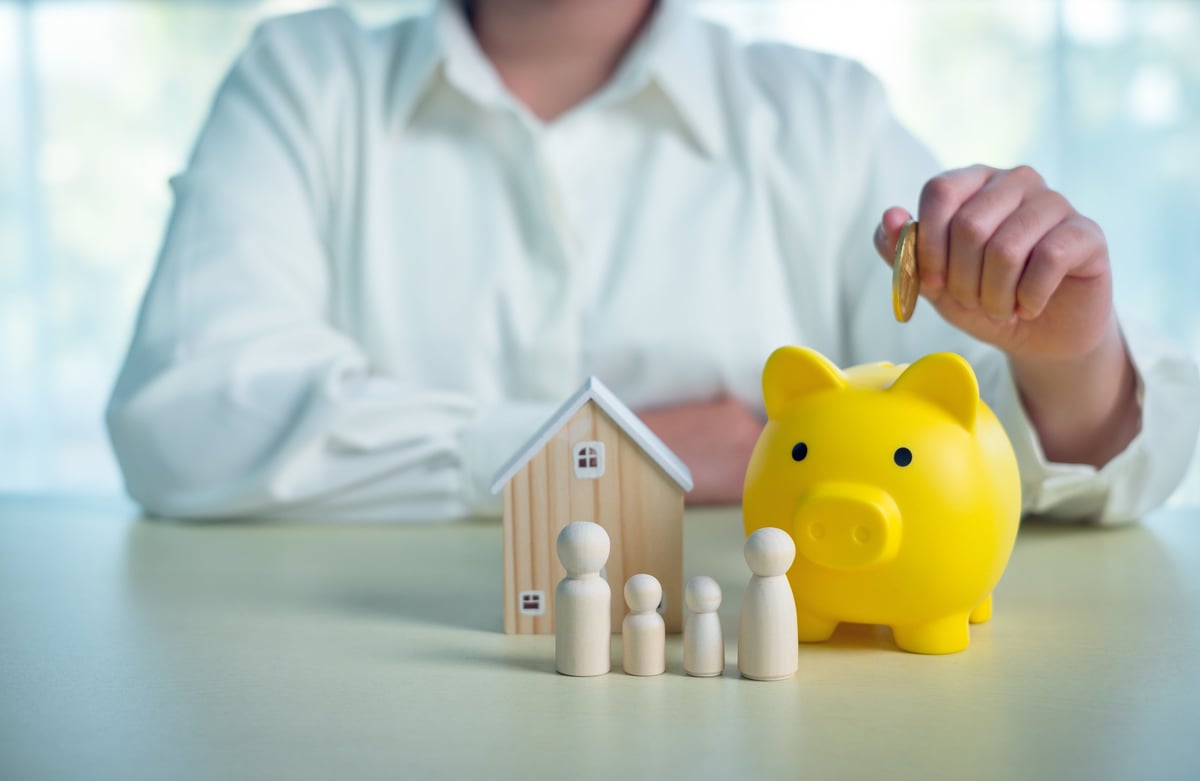 Family financial planning with piggy bank and house model